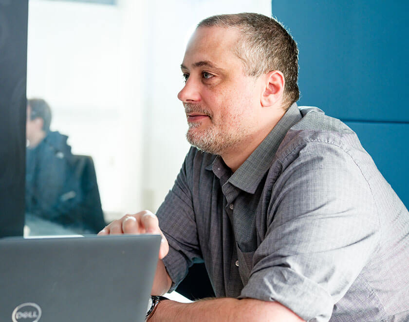 Man smiling with a laptop