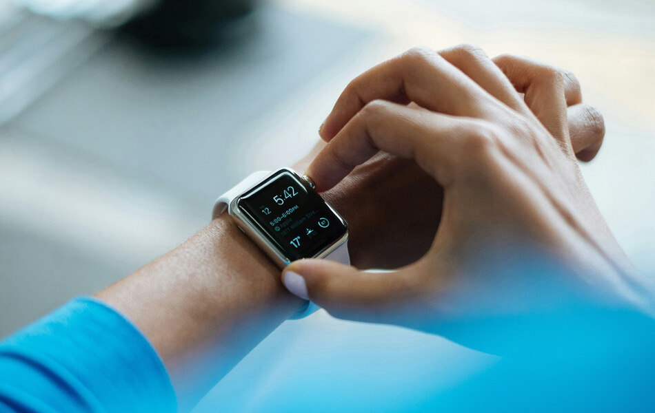 an athlete checking their health data on a smart watch after a jog