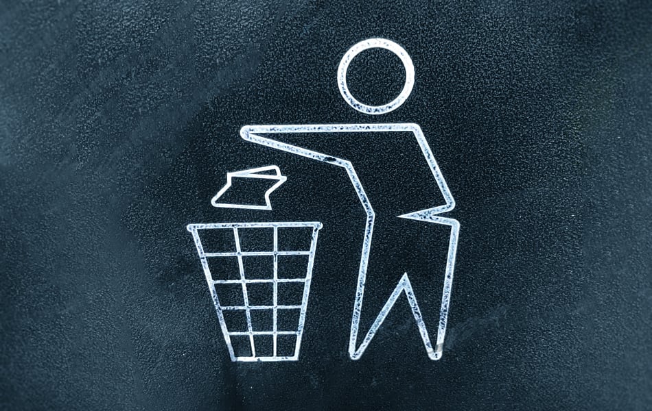 a painted recycle emblem shows a stick man dropping a piece of paper into a bin