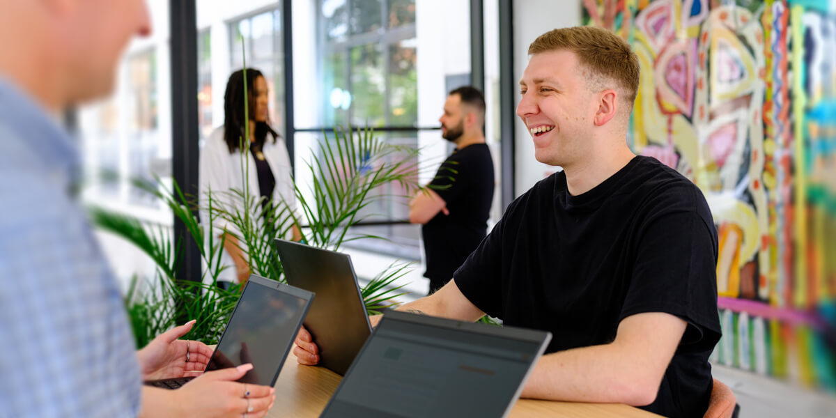 a person laughing in a bright and modern meeting room