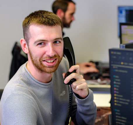 An IT technician speaks to a supplier over the phone