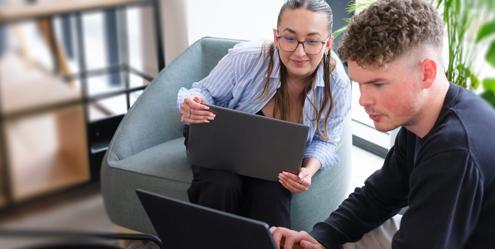 two colleagues working together in a relaxed meeting space